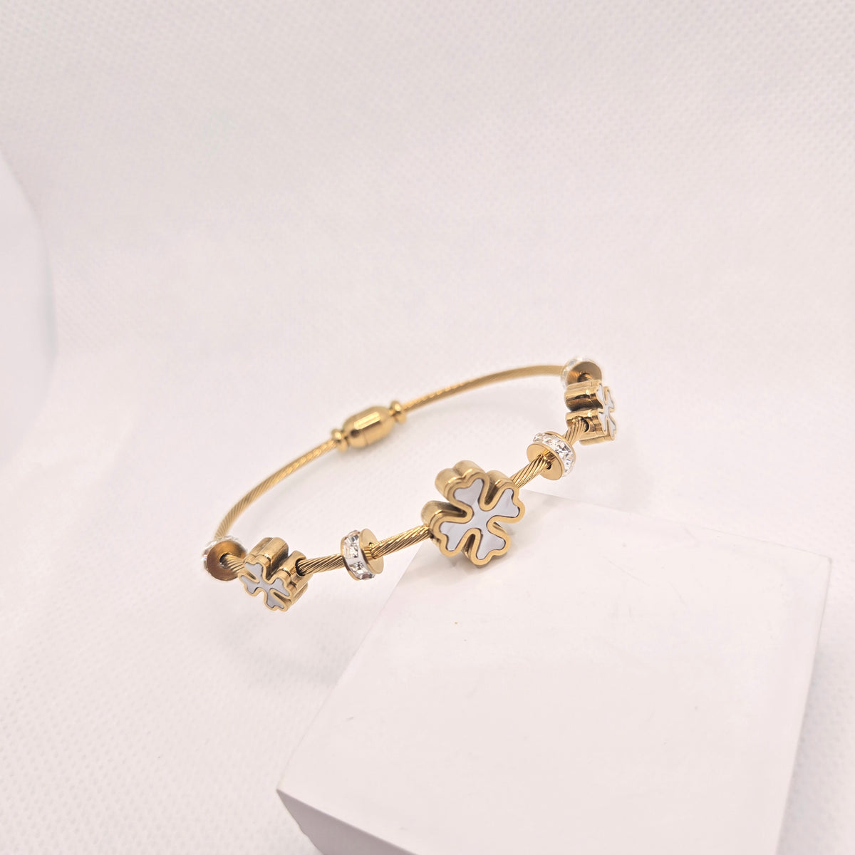 Gold-Toned Clover Charm Bangle with Pale Inlays